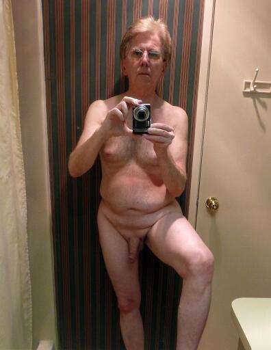 Andrew standing nude in the bathroom fully shaved and totally exposed.